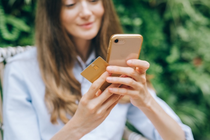 Woman with phone and credit card