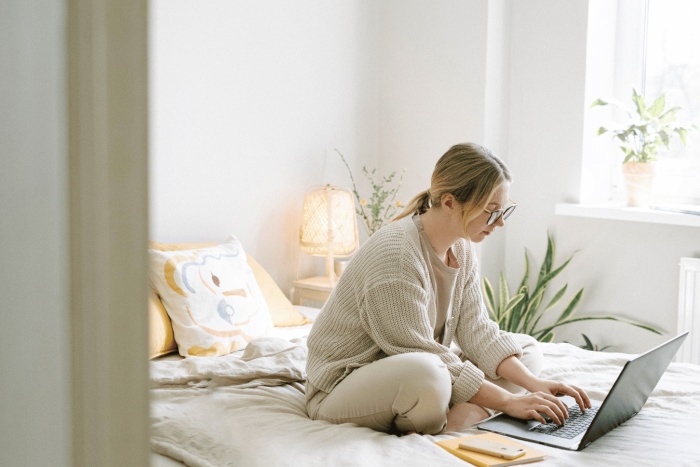 Woman working on bed